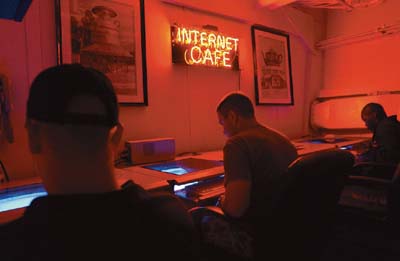 Seamen surf the Web in an Internet cafe aboard the USS Milius in the North Arabian Gulf off the coast of Iraq. 
