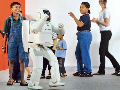 Asimo (Advanced Step in Innovative Mobility), the world's first robot that walks like a human, dances with Malaysians in Kuala Lumpur. 