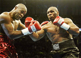 Mike Tyson hits Clifford Etienne during their heavyweight bout