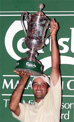 India's Arjun Atwal shows the trophy after winning the Malaysia Golf Open tournament 
