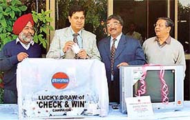 Mr Sanjay Kumar, Labour Commissioner, Punjab, takes out the lucky draw organised by the Indian Oil in Chandigarh on Monday.