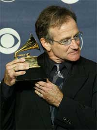 Comedian Robin Williams holds his Grammy Award