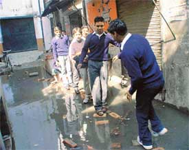 Students find difficulty in reaching school due to a blocked sewer in front of SDP Senior Secondary School