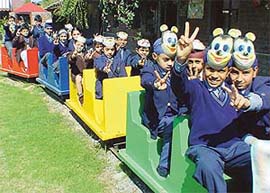 Winners of an inter-school colour competition take a joyride at Mount Carmel School