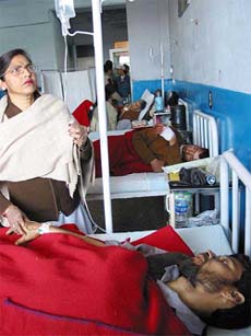 Mohammad Iqbal and Mohammad Parvez being treated in the Government Medical College hospital