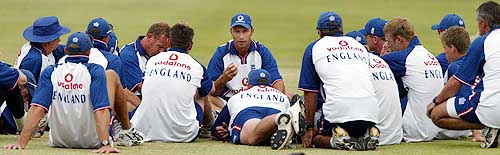 England captain Nasser Hussain talks to teammates during a training session