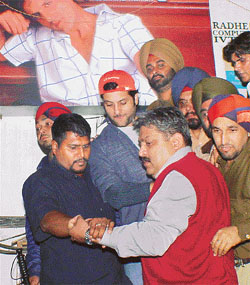 Actor Fardeen Khan being escorted out of a showroom 
