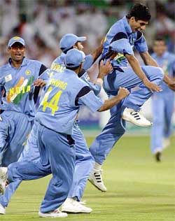 Ashish Nehra celebrates his fifth wicket
