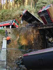 Members of the media survey the site after a train carrying about 150 passengers derailed