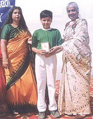 A student getting a prize at an annual day function