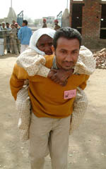A party worker helps an old woman