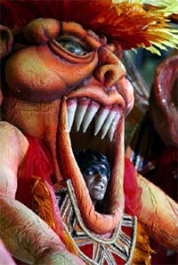 A member of the Sao Clemente samba school peers out from his costume