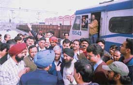 Passengers protest against the delay in the departure of a passenger train