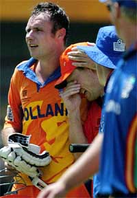 An emotional Klaas-Jan van Noortwijke of Holland is embraced by teammate Lucas van Troost 