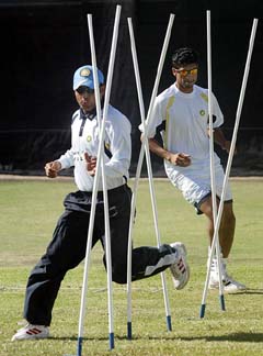 India's Virender Sehwag and Ashish Nehra warm-up during a practice session 