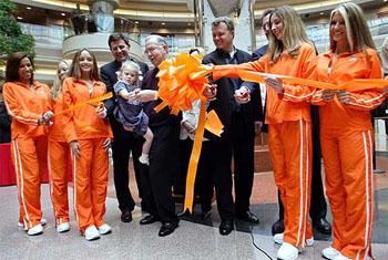 Hooters girls and executives help with a ribbon cutting with Hooters Air owner Robert Brooks