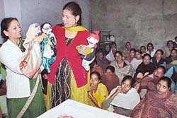 A group from the Indian Council for Children Welfare presents a puppet show as part of Women’s Week celebrations at Maloya village