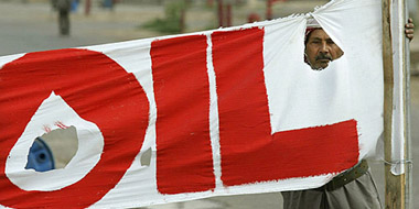 An Iraqi worker holds a banner