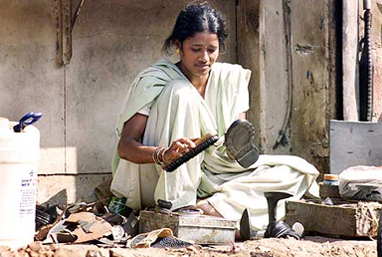 A cobbler at work on International Womens Day