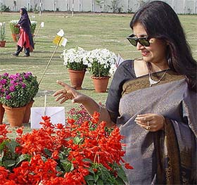 A lady admires flowers during the Northern Railway Inter-Division Flower Show Competition