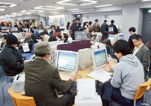 Job seekers browse the computer for information about job offers at a public employment service centre in Tokyo. 