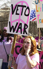 A woman holds up a Veto war sign 