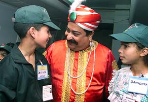 Children from Kashmir play with Air India's mascot "Maharaja" 