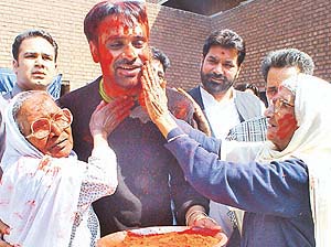 Inmates of Old Age Home, Sector 15, play Holi with Babu Mann in Chandigarh on Tuesday.