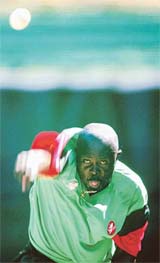 Kenyan bowler Thomas Miagi trains during a net session 