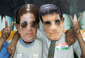 Schoolchildren, wearing masks of Indian captain Saurav Ganguly and Sachin Tendulkar, flash victory signs 