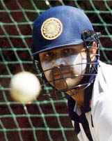 Indian batsman Virender Sehwag eyes the ball while batting at the nets during a practice session