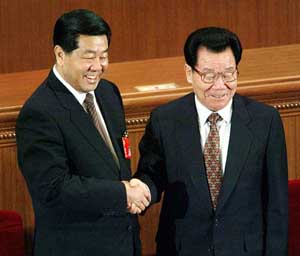 Newly elected chairman of the CPPCC Jia Qinglin, 63, is congratulated by outgoing chairman Li Ruihuan