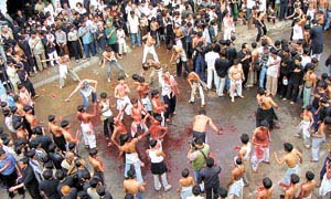 Shia youths beat their chests during the Moharram procession in the Old Delhi area