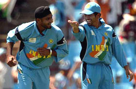 Harbhajan Singh celebrates the wicket of New Zealand's with teammate Sachin Tendulkar 