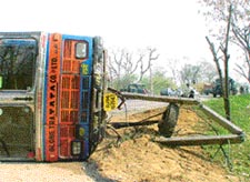 A truck lies on its side after colliding with a mini-truck near Baddowal