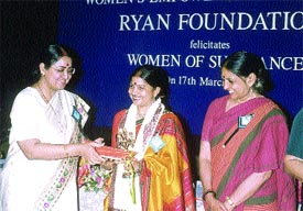 Poornima Advani, Chairperson, National Commission for Women, presents the Ryan Foundation award to Arjuna Award-winning athlete and shooter Rachana Govil
