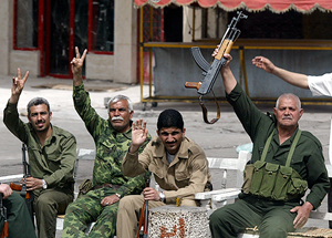 Elderly Iraqi men waves with gun in hand in Baghdad