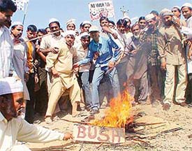 Muslims burn an effigy of US President George W. Bush in protest against the attack on Iraq, at Housing Board Chowk