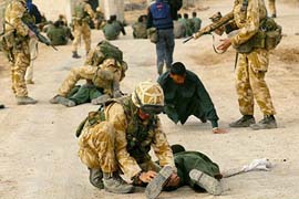 British Royal Marines from 40 Commando attend to unidentified Iraqis