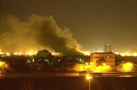 Smoke rises from one of President Saddam Hussein's palaces