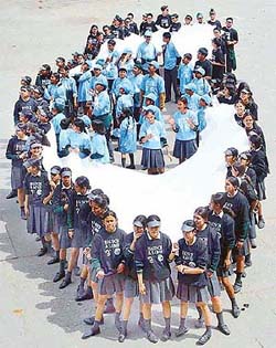 Schoolchildren make a human formation in the shape of an eye 
