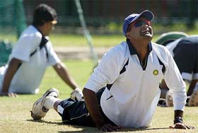 Javagal Srinath stretches during a practice session 