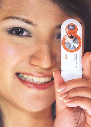 A Chinese model shows a new Philips wearable digital camera during a promotional event in Shanghai
