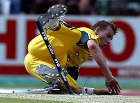 Brett Lee falls over the stumps in an attempt to effect a run out
