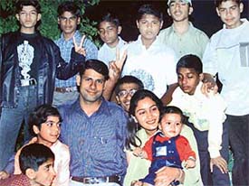 Ravinder Singh, his wife Renu, and son Deven share Ravinder’s success with children of SOS Village, Bal Niketan