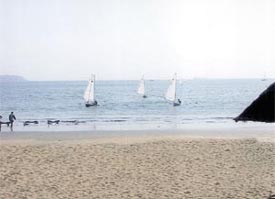 An OK Dinghy sailing practice session in progress at the Vainguinim beach in Goa