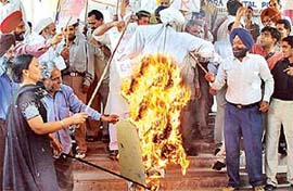 Members of various organisations burn an effigy of US President George Bush to protest against the Iraq war in Sector 17, Chandigarh