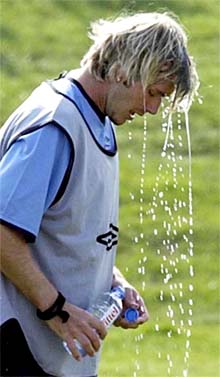 England captain David Beckham pours water over his head during an England training session 