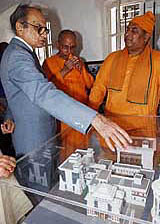 Union Tourism Minister Jagmohan examines a model of the renovated ancestral home of Swami Vivekananda