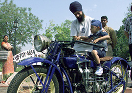 A little one tries his hand on a 1926 Handerson motorbike